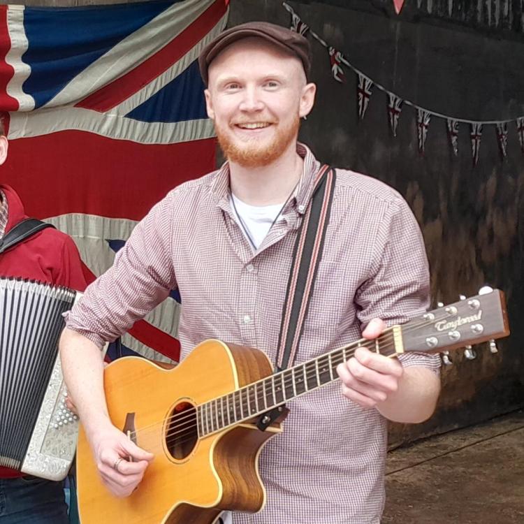 Barnbuskers Band Ryan playing guitar